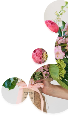 A photo of a hand holding a bouquet of pink flowers.
